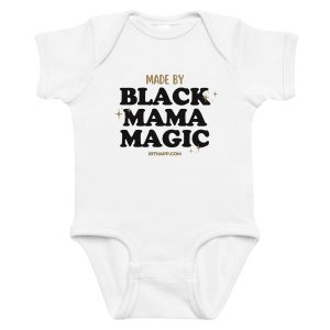A white baby onesie featuring bold text that reads 'MADE BY BLACK MAMA MAGIC' with a website link.