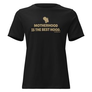 A black t-shirt featuring the phrase 'MOTHERHOOD IS THE BEST HOOD.' in bold, gold lettering, highlighting a playful take on motherhood.